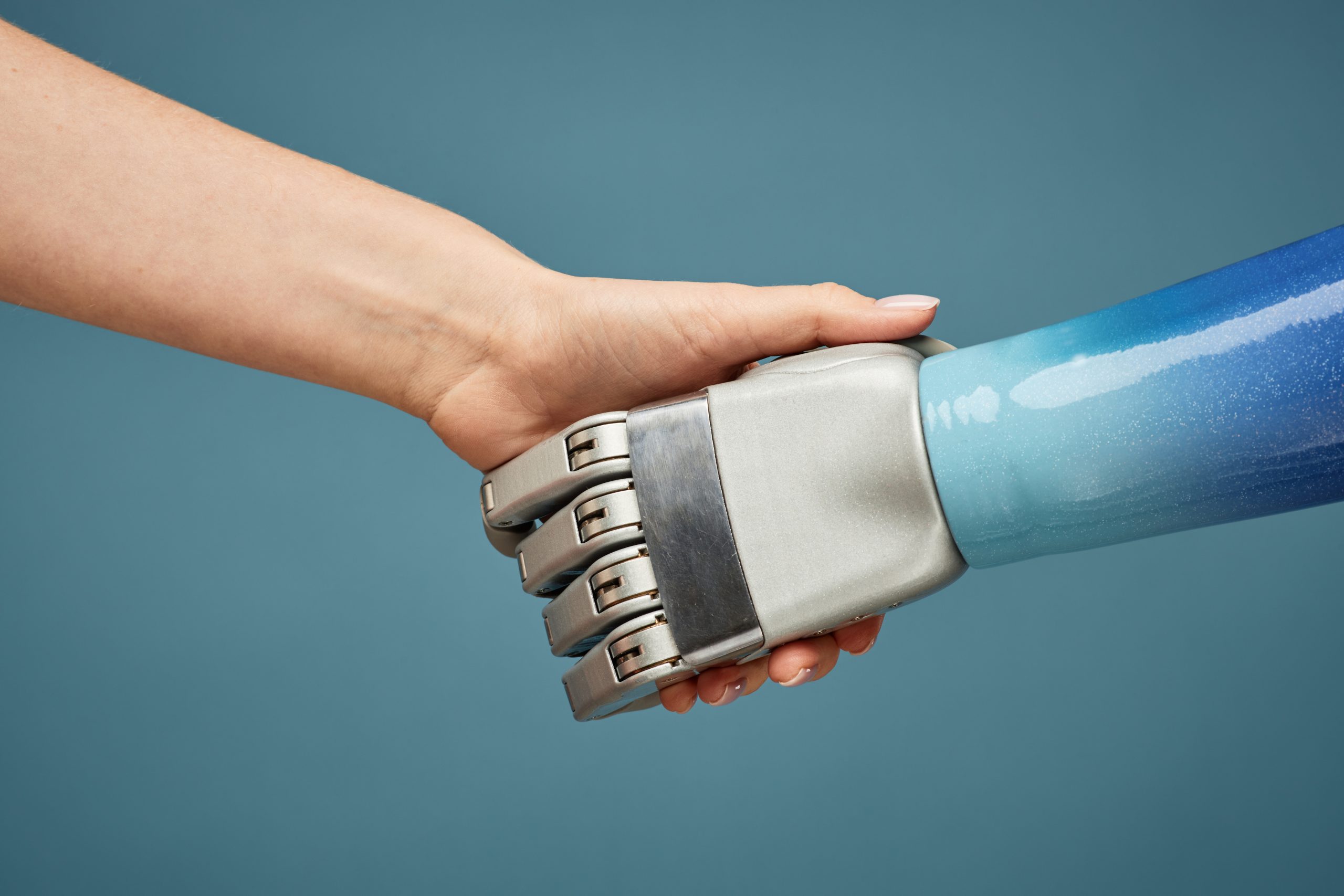 Mensch und Roboter reichen sich die Hand